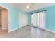 Bedroom with light blue walls, closet, and floor-to-ceiling windows with curtains at 2303 58Th E St, Palmetto, FL 34221