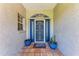 Inviting front entrance with tiled porch, blue door, and decorative planters at 2303 58Th E St, Palmetto, FL 34221