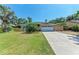 Charming home with a two-car garage, lush landscaping, and spacious driveway for multiple cars at 2303 58Th E St, Palmetto, FL 34221
