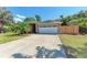 Exterior view of home featuring a two-car garage, concrete driveway, and well-manicured front yard at 2303 58Th E St, Palmetto, FL 34221