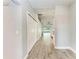 Hallway featuring wood-look tile floors and a bright, neutral color palette at 2303 58Th E St, Palmetto, FL 34221