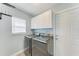 Laundry room with washer, dryer, cabinets and door at 2303 58Th E St, Palmetto, FL 34221