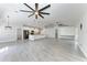 Expansive living room featuring modern ceiling fans and an open floor plan flowing into the kitchen at 2303 58Th E St, Palmetto, FL 34221