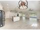Open concept living space adjacent to kitchen with vaulted ceiling and sliding glass doors to lanai at 2303 58Th E St, Palmetto, FL 34221