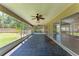 Large screened-in patio with brick flooring, multiple ceiling fans, and outdoor access at 2303 58Th E St, Palmetto, FL 34221