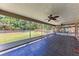 Large screened-in patio overlooking the backyard with brick flooring and fans at 2303 58Th E St, Palmetto, FL 34221