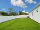 A fenced backyard with healthy, green grass at 2319 Webber St, Sarasota, FL 34239