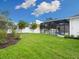 A grassy backyard with white fencing at 2319 Webber St, Sarasota, FL 34239