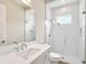 Bathroom features a glass enclosed shower, white subway tile, and modern fixtures at 2319 Webber St, Sarasota, FL 34239