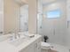 Bright bathroom features a glass shower enclosure with a small window for natural light at 2319 Webber St, Sarasota, FL 34239