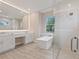 Modern bathroom with a soaking tub, glass shower, and double vanity at 2319 Webber St, Sarasota, FL 34239