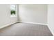 This bright bedroom has neutral carpet and paint and a window overlooking the neighborhood at 2319 Webber St, Sarasota, FL 34239