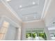 An illuminated tray ceiling and a window with a view of the lush backyard at 2319 Webber St, Sarasota, FL 34239