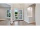 Grand foyer with wood flooring, a chandelier, and a view through glass doors to the outside at 2319 Webber St, Sarasota, FL 34239