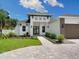 A beautiful home featuring a two-car garage, and landscaping at 2319 Webber St, Sarasota, FL 34239