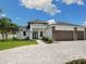 Beautiful home featuring a three-car garage, a driveway, and landscaping at 2319 Webber St, Sarasota, FL 34239