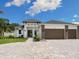 Beautiful home featuring a three-car garage, a driveway, and landscaping at 2319 Webber St, Sarasota, FL 34239