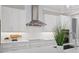 Stylish kitchen featuring sleek white cabinets, stainless steel range hood, and modern countertop at 2319 Webber St, Sarasota, FL 34239
