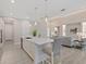 Bright kitchen with a large marble island, stainless steel appliances, and pendant lighting at 2319 Webber St, Sarasota, FL 34239