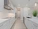 Contemporary kitchen with white cabinets, stainless steel appliances, and modern lighting fixtures at 2319 Webber St, Sarasota, FL 34239