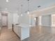Open concept kitchen featuring a large island, pendant lighting, and spacious layout at 2319 Webber St, Sarasota, FL 34239