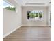 Bright room with large windows, tile floors, and crown molding at 2319 Webber St, Sarasota, FL 34239