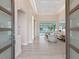 Bright, open-concept living area with neutral tones, seamlessly flowing into the pool area with expansive windows at 2319 Webber St, Sarasota, FL 34239