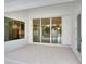 Covered patio features sliding glass doors and a view into the living room and kitchen at 2319 Webber St, Sarasota, FL 34239