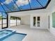 Screened patio with pool and spa has a view of the backyard and covered patio at 2319 Webber St, Sarasota, FL 34239