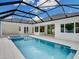 Sparkling pool with screened enclosure, featuring a spa and spacious patio for outdoor enjoyment at 2319 Webber St, Sarasota, FL 34239