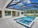 A beautiful in-ground pool and jacuzzi combination under a screened enclosure at 2319 Webber St, Sarasota, FL 34239