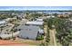 Stunning aerial view of a waterfront neighborhood with lush landscaping, manicured lawns, and mature trees at 238 Lookout Point Dr, Osprey, FL 34229