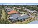 Aerial view of a residential neighborhood with well-maintained homes, lush greenery, and mature trees at 238 Lookout Point Dr, Osprey, FL 34229