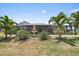 Well-manicured backyard with lush landscaping and a tiered fountain, creating a serene outdoor oasis at 238 Lookout Point Dr, Osprey, FL 34229