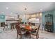 Elegant dining room with wooden table, chandelier, and bar area, open to the kitchen at 238 Lookout Point Dr, Osprey, FL 34229
