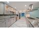 Well-equipped kitchen with white cabinets, granite countertops, stainless steel appliances, and marble tile flooring at 238 Lookout Point Dr, Osprey, FL 34229