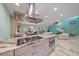 Modern kitchen with a marble island, stainless steel appliances, and an open view to the living area at 238 Lookout Point Dr, Osprey, FL 34229