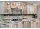 A kitchen sink with a decorative backsplash, stainless steel appliances and marble countertops at 238 Lookout Point Dr, Osprey, FL 34229