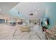 Open-concept living space featuring light blue walls, marble floors, comfortable seating, and a dining area at 238 Lookout Point Dr, Osprey, FL 34229