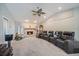 Inviting living room with stone fireplace, recliner seating, and large screen TV at 238 Lookout Point Dr, Osprey, FL 34229