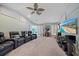 Cozy living room area with recliner seating, a large TV, and nautical décor at 238 Lookout Point Dr, Osprey, FL 34229