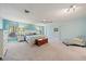 Bright main bedroom with carpet, ceiling fan, blue walls and beach decor accents at 238 Lookout Point Dr, Osprey, FL 34229