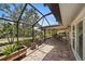 Screened patio with brick flooring, an outdoor kitchen, and lush landscaping offers the perfect outdoor retreat at 238 Lookout Point Dr, Osprey, FL 34229