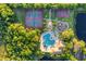 Aerial view from above showcases community amenities, including tennis courts, a pool, a clubhouse, and a playground at 246 Petrel Trl, Bradenton, FL 34212