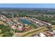 Expansive aerial view of the residential community, highlighting the tranquil lake and lush surrounding landscape at 246 Petrel Trl, Bradenton, FL 34212