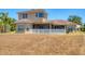 Rear exterior view highlighting the screened lanai and spacious backyard, perfect for outdoor relaxation and entertainment at 246 Petrel Trl, Bradenton, FL 34212