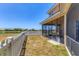Backyard view of white picket fence, lake and the screened-in porch at 246 Petrel Trl, Bradenton, FL 34212