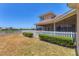 Backyard view of white picket fence, landscaping, lake and the screened-in porch at 246 Petrel Trl, Bradenton, FL 34212