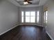 Bright bedroom features stylish wood floors, tray ceilings, and a bay window overlooking the backyard at 246 Petrel Trl, Bradenton, FL 34212