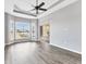 Bedroom with hardwood flooring, tray ceiling, bay window, and sliding door access at 246 Petrel Trl, Bradenton, FL 34212
